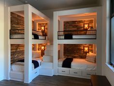 three bunk beds in a room with white walls and wood flooring on the sides