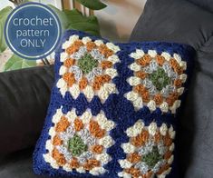 a crochet pillow sitting on top of a couch next to a potted plant