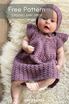 a baby wearing a purple crochet dress and bonnet laying on a white rug