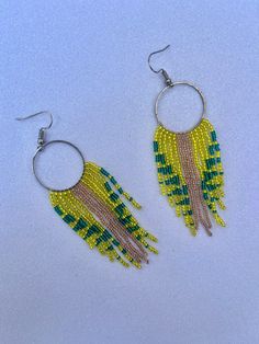 Handwoven seed bead earrings using yellow, green, and gold Czech seed beads. Each bead has been touched by my hand multiple times, a lot of time and energy goes into each piece. Please note that color/tone may differ in person due to monitor brightness and other settings. Green Dangle Beaded Earrings With Gold Beads, Yellow Dangle Earrings With Tiny Beads, Yellow Beaded Earrings With Tiny Beads As A Gift, Yellow Beaded Earrings With Gold Round Beads, Bohemian Green Earrings With Gold Beads, Yellow Gold Beads Drop Earrings, Yellow Gold Beaded Drop Earrings, Yellow Gold Beaded Round Earrings, Colorful Beaded Drop Earrings In Yellow