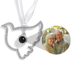 an ornament with a photo of two people in the shape of a heart