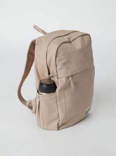 Need a backpack that's both sustainable and practical for college, school everyday use or outdoor activities? Our Earth Backpack is perfect for you. Our spacious and durable Earth Backpack is the workhorse of our line, built for everyday carry with heavy-duty certified organic cotton canvas. The generous main compartment is divided with a no-fuss sleeve for your laptop and one small interior pocket to keep things organized. Two water bottle sleeves and the large zippered exterior pocket keep hyd Best Backpacks For College, Backpack For College, Beige Backpacks, Sustainable Backpack, Handmade Backpacks, Everyday Backpack, Our Earth, College Backpack, Cool Backpacks