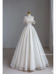 a white wedding dress on a mannequin