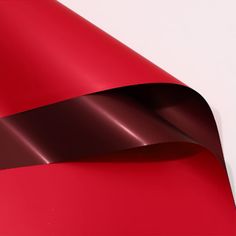 a close up view of a shiny red surface