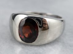 The ultimate 'go with anything' ring, this vintage mounting is low to the hand and has a sleek unisex design, making it comfortable to wear day or night! The polished bezel and inset setting protect the deep, wine-red garnet set in the center.Metal: 14K White GoldGem: Garnet 2.41 CaratsGem Measurements: 9.4 x 7.5 mm, OvalRing Size: 8Marks: “14K” Stamped on the inside band Formal Garnet Ring With Polished Finish, Classic Garnet Rings With Bezel Setting, Modern Ruby Ring With Bezel Setting For Formal Occasions, Classic Garnet Signet Ring For Formal Occasions, Formal Garnet Signet Ring, Classic Garnet Signet Ring For Anniversary, Modern Garnet Rings For Formal Occasions, Modern Garnet Rings For Formal Events, Timeless Ruby Ring With Polished Finish For Formal Occasions