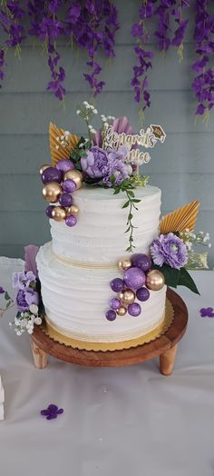 Beautiful Rustic and elegant 2 tier tall cake. Wood base Floral Cake 2 Tier, Lavender Theme Cake, Purple And Gold Cakes, Purple And Gold Birthday Cake, Purple Gold Cake, Purple Graduation Cake, Lavender Color Cake, Purple Floral Cake