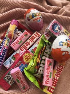 a pile of candy sitting on top of a bed