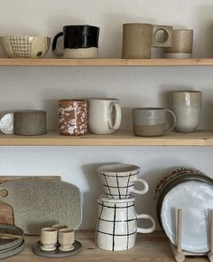 some shelves filled with different types of cups and saucers on top of each other