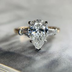 an oval cut diamond ring with three baguets