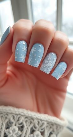 Discover how to rock snowflake elegance with this winter nail design. A frosty blue or white base with delicate snowflakes is the perfect holiday vibe. 💅❄️ Blue Christmas Nails Winter Snowflake Designs White, Holiday Snowflake Nails, Red French Tip Nails Snowflake, White And Blue Snowflake Nails, Baby Blue Nails With Snowflakes, Christmas Nails Short Snowflake, Blue Snowflakes Nails, Navy Snowflake Nails, Christmas Nails White And Blue