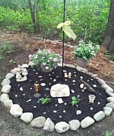 a small garden with rocks and plants in the middle, including an umbrella over it