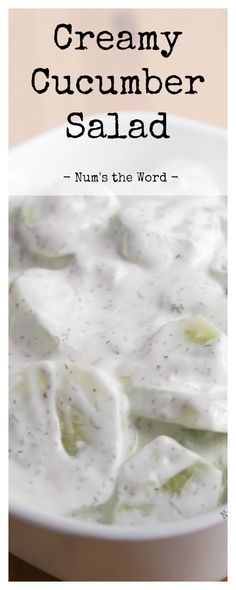 creamy cucumber salad in a white bowl with the words, num's the word