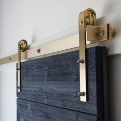 a close up of a wooden door with brass hardware