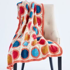 a crocheted blanket sitting on top of a chair