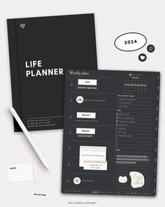 the life planner is next to a pen and paper