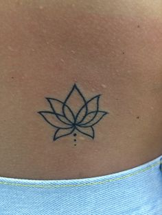 a lotus tattoo on the back of a woman's neck