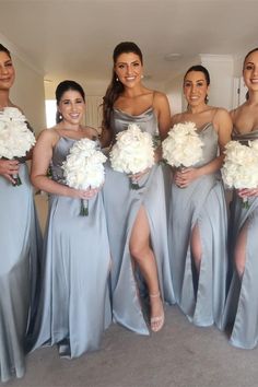 the bridesmaids are all wearing gray dresses with white flowers in their bouquets