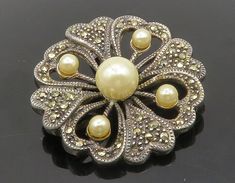 "925 Sterling Silver - Vintage Pearls & Marcasite Floral Brooch Pin - BP5163  925 Sterling Silver - Vintage Pearls & Marcasite Floral Brooch Pin - BP5163  Jewelry Type:         Brooch Pin  Metal Type:            925 Silver  Metal Size:             1.5\"  Stone Type:            Pearls & Marcasite   Condition:              N/A  Jewelry Weight:     11.7 Grams  PLEASE NOTE: THIS ITEM IS PRE-OWNED. ALTHOUGH MOST ITEMS ARE IN VERY GOOD CONDITION, SOME MAY NEED CLEANING AND/OR MINOR REPAIRS. WE MAKE A VERY STRONG EFFORT TO UPLOAD CLEAR PICTURES. PLEASE INSPECT ALL PICTURES AND ASK ALL QUESTIONS YOU MAY HAVE PRIOR TO MAKING A PURCHASE. NOT ALL STONES ARE GENUINE, SOME ARE ENHANCED OR CREATED." Silver Art Deco Brooches For Wedding, Silver Art Deco Wedding Brooches, Silver Art Deco Wedding Brooch, Antique Silver Wedding Brooches, Vintage Sterling Silver Brooches For Wedding, Vintage Sterling Silver Wedding Brooches, Vintage Sterling Silver Brooch For Wedding, Gold Sterling Silver Brooches For Wedding, Antique Sterling Silver Brooches For Wedding