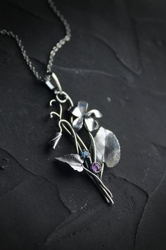 ITEM DESCRIPTION: The size H 5 cm x W 3 cm (2 x 1 1/3 inch). Weight - 3 g. You can buy it with a silver chain or without it. This spring flower is so delicate. So I was inspired by nature and made a wild violet flower of sterling silver, amethyst, and blue zircon. This is a very detailed handmade necklace. This floral jewelry will be a great addition to your jewelry collection or gift for someone whose you love. This handmade necklace will come to you in a gift box - ready for gifting. The parce Unique Flower Pendant Necklaces With Charm, Silver Nature-inspired Necklace With Flower Charm, Silver Necklace With Nature-inspired Flower Charm, Nature-inspired Flower Charm Pendant Necklace, Nature-inspired Silver Flower Necklace With Charm, Nature-inspired Sterling Silver Flower Jewelry, Nature-inspired Flower Shaped Sterling Silver Jewelry, Sterling Silver Birth Flower Pendant Necklace, Botanical Silver Jewelry With Birth Flower