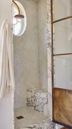 a bathroom with white marble and gold accents