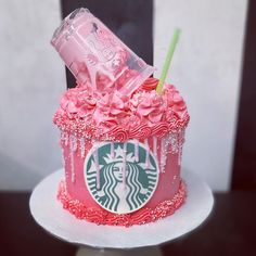 a starbucks cup cake with pink frosting and roses