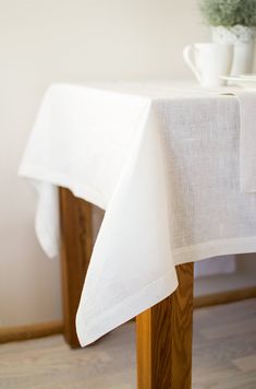 a white table cloth on top of a wooden table