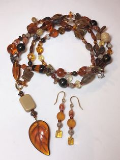 Wonderful mix of contemporary Czech and vintage German glass. There are a lot of special beads in my mixes, many discontinued styles. NOTE: The last picture is an example of what the mix can make. I made the earrings and necklace with ONE package of this mix AND 1 leaf that wasn't in the bag I randomly picked. They're were less than 10 beads left over. I used size 8 seed bead (not included in mix) as spacers between each mix bead. Mix Name: Topaz Hues Quantity: 50 gram bags Shape: Mixed. Each 50 Handmade Brown Czech Glass Beads, Brown Glass Beads For Jewelry Making, Earthy Brown Beads For Jewelry Making, Handmade Brown Glass Beads, Vintage Brown Beads For Jewelry Making, Topaz Color, Earrings And Necklace, Glass Bead, Seed Bead