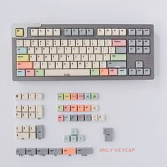 a computer keyboard with several different colored keys on the bottom and one key below it