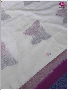 A pristine white soft silk saree featuring a tableau of butterfly patterns half adorned in royal purple threads and half in serene blue threads. The charming butterfly motifs dance across the fabric, creating a mesmerizing blend of grace and vibrancy. This borderless ethereal white saree leads to a captivating purple pallu that intricately unfolds into a tapestry of enchanting floral designs woven with delicate blue threads. This elegant combination captures the essence of sophistication, blendi White Silk Dupatta With Traditional Patterns, White Silk Saree With Motifs, Elegant White Dupatta With Motifs, White Katan Silk Saree With Traditional Patterns, Butterfly Patterns, New Year Special, White Saree, Blue Florals, Soft Silk Sarees