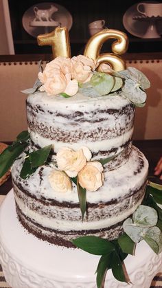 a three tiered cake with flowers on top