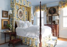 a bedroom with blue walls and yellow curtains