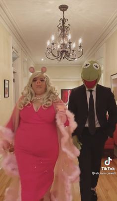 the muppet and miss piggy are walking down the hall in their wedding outfits