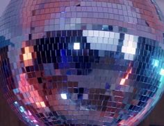 a shiny disco ball sitting on top of a wooden table