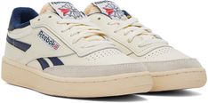 Low-top paneled buffed leather sneakers in off-white and navy. · Suede trim at round toe · Perforated detailing at vamp · Lace-up closure · Logo flag at tongue · Padded collar · Logo stamped at heel tab · Logo woven at outer side · Terrycloth lining · Logo embossed at textured rubber midsole · Treaded rubber outsole Supplier color: Chalk/Alabaster/Vector navy Club C Revenge, Reebok Classics, Vintage Sneakers, Club C, Terry Cloth, Luxury Streetwear, Leather Sneakers, Revenge, Low Top