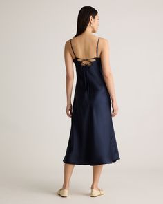 A playful twist on a classic silk dress, meet our 100% Washable Silk Cutout Midi Slip Dress. This super flattering fit is made from 100% mulberry silk, in a satin finish. The kicker? Our silk is washable. Easy to style, easy to wash for low-maintenance luxe. Plus, silk fiber contains 18 kinds of amino acids that make it amazing for skin nourishment, hypo-allergenic, and naturally thermoregulating to help maintain body temperature.  | Quince | Women's Cutout Midi Slip Dress in Navy, Size Medium, Silk Knee-length Satin Dress For Date Night, Silk Slip Dress With Satin Finish, Silk Satin Dress For Date Night, Silk Satin Dress With Bias Cut For Date Night, Silk Satin Bias-cut Dress For Date Night, Silk Midi Slip Dress With Satin Finish, Satin Silk Dress With Satin Finish, Midi Length, Silk Satin Midi Dress With Satin Finish, Midi-length Silk Dress With Satin Finish