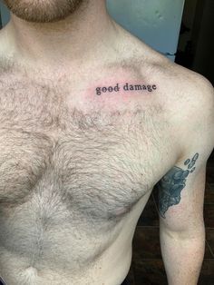 a man with a tattoo saying good damage on his chest