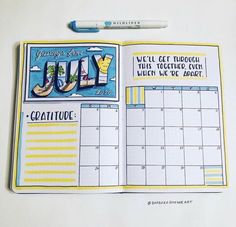 an open planner with the word july on it