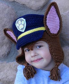 a young child wearing a crocheted hat with ears and ears on it's head