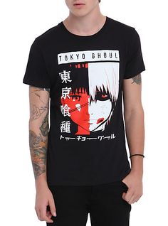 a young man wearing a black tshirt with an anime image on the front