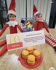 two elfs are sitting at a table with mcdonald's burgers and hamburger patties