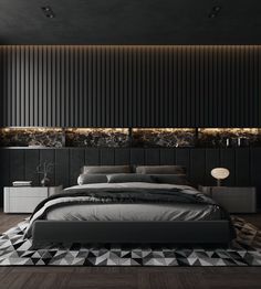 a modern bedroom with black walls and wood flooring, an upholstered bed