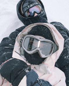 a person wearing goggles and a jacket in the snow