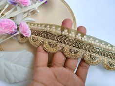 This intricately designed Sari Border Trim is perfect for accentuating your fancy Dupatta, Suits, Lehengas, or Wedding Dress creations. Crafted with precision and passion, this delicate lace boasts a beautiful pale yellow hue, radiating a sense of sophistication and charm. The intricate scallop pattern adorned with shimmering golden sequins adds a luxurious touch, making it a captivating choice for embellishing your special outfits and crafts. Use it in multipurpose projects: ➤Dress border, saree, dupattas, scarves and veils ➤Headband, hats ➤Shrugs, skirts, tunics, ➤Table runner, curtains ➤For making a DIY belt ➤Book binding embellishment, ➤Waist belt to match your plain outfit ➤Festive wear, wedding wear, dresses ➤Gypsy, Boho, Bohemian Ethnic wear, tunics and salwar/Kurtis. ➤Embellish you Gold Lehenga With Resham Embroidery For Ceremony, Gold Lehenga With Pallu For Ceremony, Traditional Dori Work Embroidered Fabric For Ceremony, Gold Embroidered Fabric With Dori Work For Wedding, Fitted Gold Dupatta With Lace Work, Festive Gold Lehenga With Lace Work, Gold Lehenga With Lace Work For Wedding, Traditional Gold Lace With Lace Work, Traditional Embroidered Fabric With Lace Work For Ceremonies