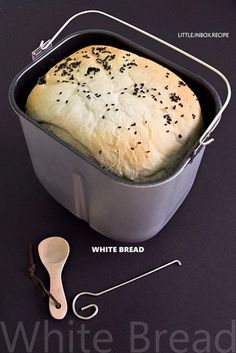 a loaf of bread sitting in a pan next to a spoon