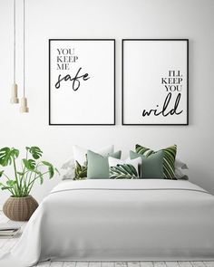 two posters on the wall above a bed in a white bedroom with green pillows and throw pillows