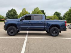 a blue truck parked in a parking lot