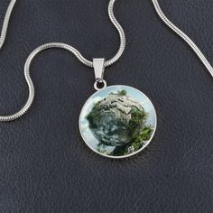 Imagine the feeling of your feet firmly planted on the earth, drawing strength from its core. This necklace embodies the grounding energy of the Earth element, reminding you to find stability within yourself and nurture your own growth. Purchase This Best-Seller and We Guarantee It Will Exceed Your Highest Expectations! ➜ Our patent-pending jewelry is made of high quality surgical steel with an 18k gold finish option. This Jewelry Item Is the Perfect Keepsake! Whether for Yourself or a Loved One. ➜ If the custom engraving option is available, engrave onto the back of the pendant your loved one's name, your wedding date, an anniversary, or anything else you want to remember and keep you close to her heart. Each personalized piece offers exceptional craftsmanship that is fit to be an instant Nature-inspired Healing Necklace With Round Pendant, Nature-inspired Silver Necklace For Meditation, Nature-inspired Silver Meditation Necklace, Nickel-free Round Pendant Necklace For Healing, Unique Round Stainless Steel Necklaces, Unique Round Stainless Steel Necklace, Element Necklace, Earth Elements, Watch Bands