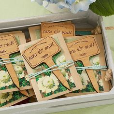 small wooden tags in a box tied with twine and flowers on the inside one