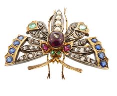 "A stunning Victorian butterfly brooch worked in 14K yellow gold and silver. The body comprises a cabochon garnet inset with a rose cut diamond, all set between a pair of bright green emerald eyes and a tapering tail of natural pearls The delicately pierced wings are set with 24 rose cut diamonds, two rubies, two emeralds and eight blue sapphires. The butterfly is completed with gold legs and antennae. The brooch is beautifully made. Tested and guaranteed 14K gold. * Origin: America, ca. 1880. * Victorian Butterfly, Emerald Eyes, Diamond Butterfly, Gold Legs, Ruby Emerald, Butterfly Brooch, Green Emerald, The Butterfly, Rose Cut Diamond