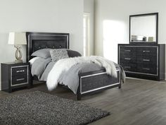 a bedroom scene with focus on the bed and nightstands, which are also in black